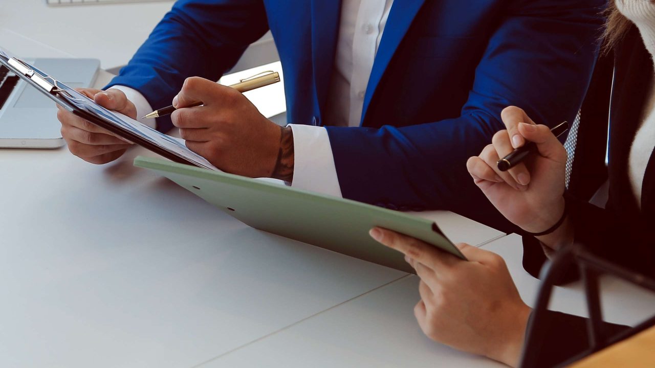Entrepreneur Asian businessman and businesswoman discussing new business project in tablet in modern Meeting In Modern Office, Asian business casual concept.